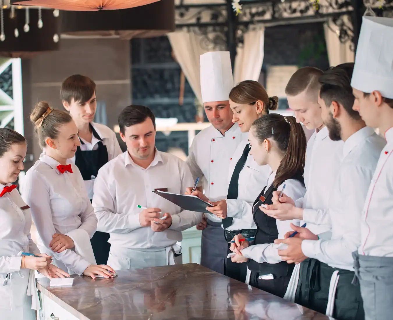 Feastra catering team serving gourmet fare at an elegant outdoor event in Virginia, showcasing warm hospitality and premium service.